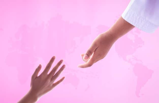 A hand reaching out to hold another hand, with a stethoscope draped over them. The background is blurred, emphasizing the human connection and care in healthcare.