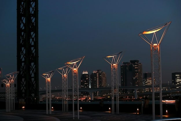 A night-time view of a city skyline, with the foreground showing smart electric grids with bright lines connecting buildings and energy sources. This symbolizes the modernization of energy infrastructure and the integration of smart technologies.