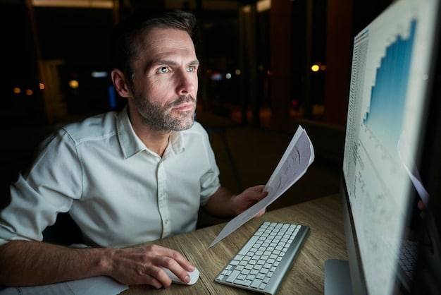 A close-up shot of an economist sitting at a desk, reviewing data on multiple computer screens. The screens display graphs, charts, and economic indicators, emphasizing the complexity and detail involved in economic forecasting.