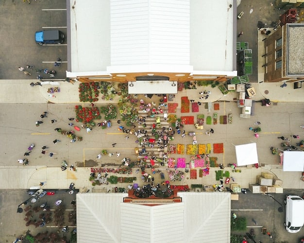 Overhead vibrant shot of a diverse group of people shopping at an upscale outdoor market, featuring local crafts, produce, and food stalls. The atmosphere is lively, with people interacting, smiling, and making purchases.
