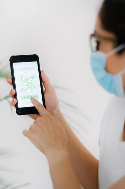 Close-up shot of a hand scanning a QR code on a pharmaceutical package, using a smartphone. The screen displays blockchain verification data, showing the medicine's authenticity and origin.