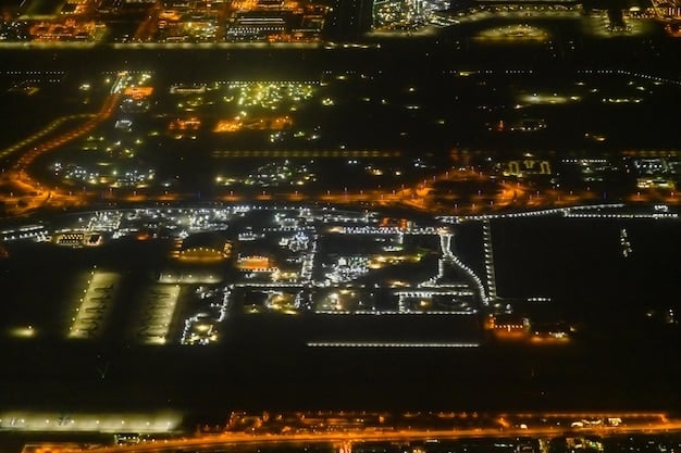 An aerial view of a city at night, highlighting the smart grid infrastructure with illuminated power lines and substations, showcasing the advanced technology that optimizes energy distribution.
