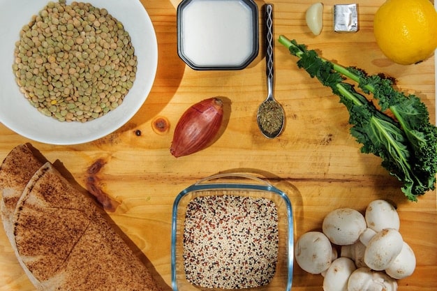 A diverse array of sustainable protein sources, including lentils, quinoa, insect-based snacks, and lab-grown meat samples, arranged on a rustic wooden table to emphasize their natural and eco-friendly qualities.