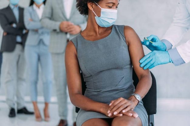 A close-up shot of a healthcare professional administering a flu vaccine to a patient's arm, with a focus on the needle and the sterile environment. The image emphasizes the safety and medical procedure of getting vaccinated.