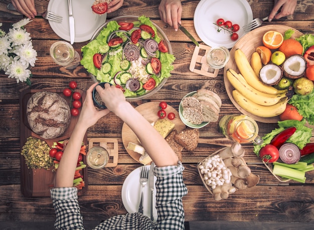 A table setting with a variety of healthy foods, including fruits, vegetables, lean protein sources, and nuts, representing a balanced diet during the eating window in intermittent fasting.