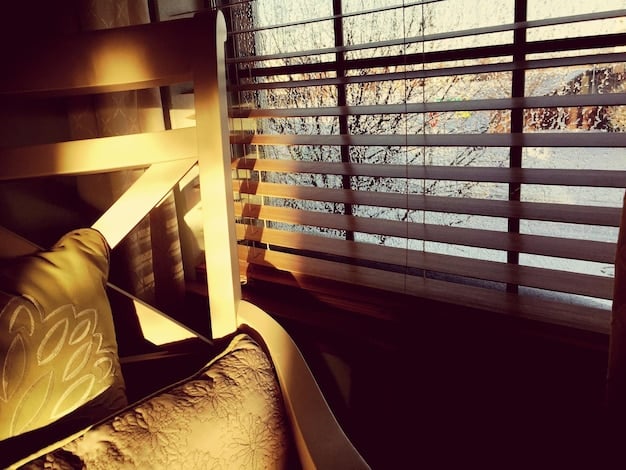 A close-up of blackout curtains effectively blocking sunlight from entering a bedroom window. The room is dark and cozy, emphasizing the importance of light control for sleep.