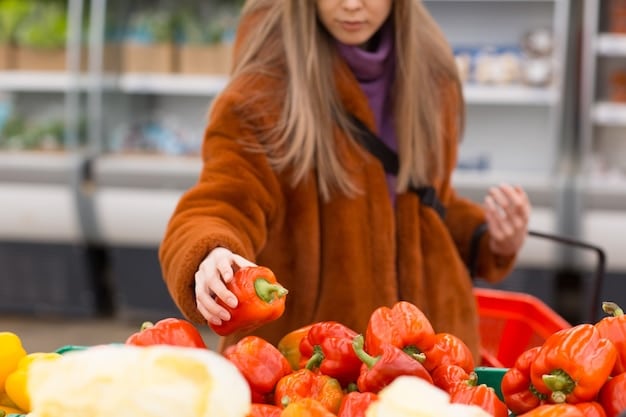 A close-up shot of a person choosing fresh produce at a farmer's market, with a focus on the vibrant colors and variety of fruits and vegetables.