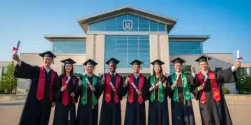 Diverse graduates in caps and gowns celebrating in front of university, symbolizing tuition-free success.